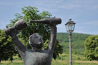 Detail of the winegrower's fountain with wine jug and wine bottle being poured in the wine-growing area of Zeltingen-Rachtig