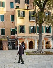 Senior citizen with walking stick in the Jewish quarter of Venice