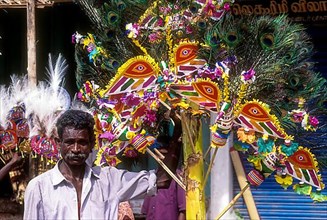 A man holding a decorated plantain in a village festival