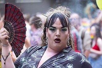 Made-up transvestite with fan at the CSD parade