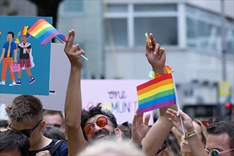 Cheering homosexual man with rainbow flag at the CSD parade