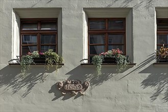 Window with year of construction 1697 on historic residential and commercial building