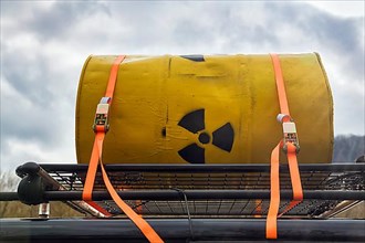 Yellow metal barrel with sign for radioactivity on roof rack