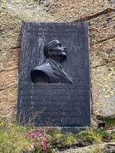 Commemorative plaque on top of Colle del Nivolet pass road in Alps for Senator Giorgio Ermanno Anselmi