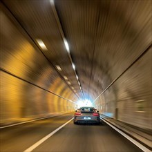 Dynamic shot with speed effect Zoom effect of sports car Porsche GT3 driving at high speed through tunnel