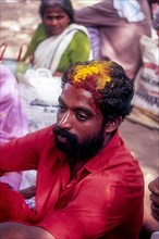 Young man relaxing after a religious ritual of Bharani festival in Kodungallur