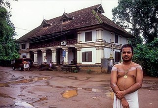 Nambudiri Priest standing in front of Pambummekkatu Mana Nagaraja Temple