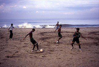 Playing football on the beach in Kozhikode