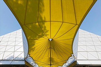 Yellow awning with shadow of a tree