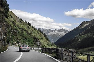 Porsche 911 GT3 sports car on well-built Alpine road from Sustenpass to Wassen
