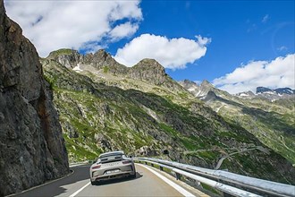 Porsche 911 GT3 sports car on a mountain road on the Susten Pass above the tree line