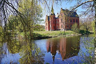 Skoovsgard Manor reflected in the water of a pond