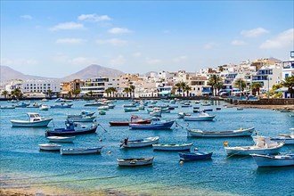 Beautiful seaside downtown of Arrecife with many boats floating on blue water