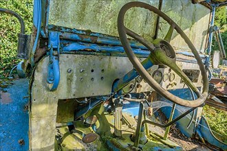 Old car rolled for scrapping in a meadow. Alsace