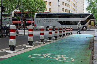 Bicycle lane with green marking and safety bollards