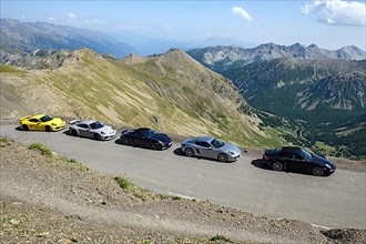 View of five Porsche sports cars on 2802 metre high highest asphalted road in Alps