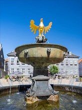 Golden eagle on the market fountain in front of the Kaiserringhaus on the market square
