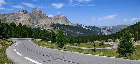Panoramic view of winding alpine road Mountain road in front of Col de l Izoard
