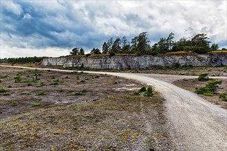 Gravel road leads through abandoned quarry