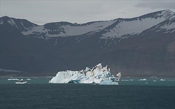 Ice chunks on the lake Joekulsarion with mountains in the background