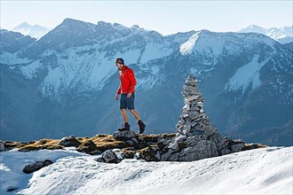 Mountaineer next to a cairn