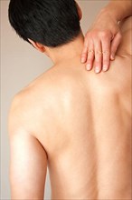 Adult nude male displaying back pain