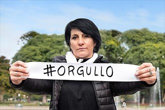 Woman holding an #orgullo or #pride sign. LGBT Concept