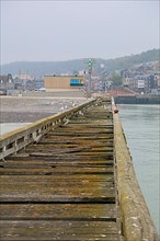 Old wooden jetty in the harbour of the coastal village of Le Treport at the mouth of the Bresle on the English Channel