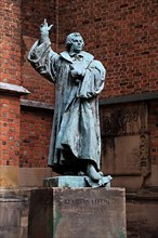 Statue of Martin Luther in front of the Protestant-Lutheran Market Church of St. Georgii et Jacobi in Gothic style