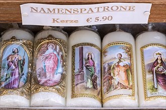 Candles with images of Mary and the saints in front of a devotional shop at Kapellplatz