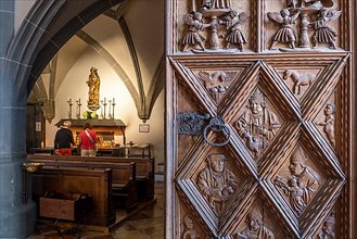 Richly decorated wooden portal with view into the collegiate parish church of St. Philip and St. James