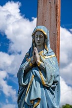 Figure of the Virgin Mary on a wooden cross in the St. Michael cemetery