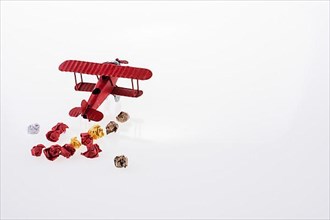 Red airplane and crumpled paper on a white background