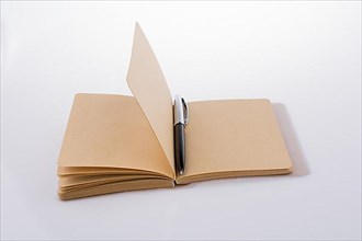 Pen on a notebook on a white background