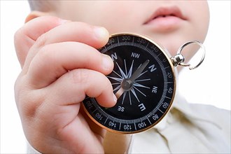 Isolated compass in baby's hand on a white background