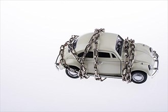 Chained white car on white background