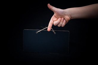 Rectangular shaped black notice board in hand on black background