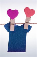 Paper clothes hang on a rope with the help of clothespins