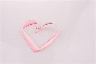 Heart made of ribbon on a white background