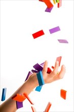 Falling colorful domino onto a hand
