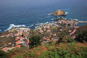 View of the village of Porto Moniz on the north-west coast of the island small offshore island Ilheu Mole