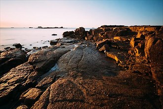Rocks on the beach of Port Blanc in the morning light