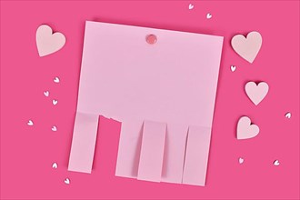 Pink empty tear-off stub paper note without text with heart ornaments,