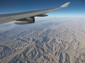 View from the plane of the inhospitable mountainous country in the region of Afghanistan, Pakistan