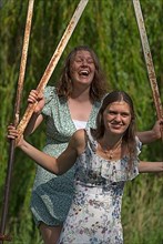 Two young girls swinging, Mecklenburg-Western Pomerania