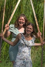 Two young girls swinging, Mecklenburg-Western Pomerania
