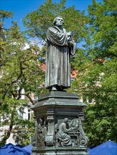 Luther monument by the sculptor Adolf von Donndorf from 1895 on Karlsplatz in Eisenach. The plinth motif shows Luther on the right in his study room at Wartburg Castle and on the left as a boy with th...