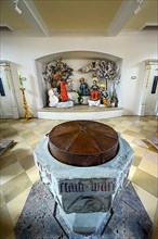 Baptismal font and figures of saints, praying disciples on the Mount of Olives