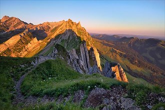 View of the Alpstein mountains in Appenzell from the mountain hiking trail, cloudless sky in the morning light