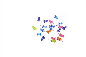 Colorful drawing-pins scattered on a white background,
